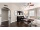 Spacious living room with hardwood floors, modern ceiling fan and neutral walls at 8875 S Ash Ave, Tempe, AZ 85284