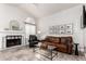 Inviting living area with fireplace, leather sofa, and tiled floors provides a cozy atmosphere at 8875 S Ash Ave, Tempe, AZ 85284