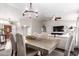 Open-concept living/dining area with chandelier, wood table and hardwood floors at 8875 S Ash Ave, Tempe, AZ 85284