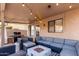 Inviting covered patio features comfortable seating, a fire pit, string lights, and a built-in grill at 8875 S Ash Ave, Tempe, AZ 85284