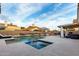 Backyard with sparkling pool, and covered patio with an outdoor kitchen and lounge area at 8875 S Ash Ave, Tempe, AZ 85284