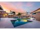 Gorgeous pool with attached jacuzzi, mature landscaping, basketball hoop, and an umbrella-covered lounge area at 8875 S Ash Ave, Tempe, AZ 85284