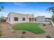 Backyard with turf lawn, desert landscaping, a sparkling pool, and sleek modern architecture at 9820 N 87Th Pl, Scottsdale, AZ 85258