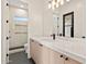 Bright bathroom with wood cabinets, marble countertop vanity, and tiled walk-in shower at 9820 N 87Th Pl, Scottsdale, AZ 85258