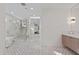 Bright primary bathroom featuring a glass enclosed shower, free standing tub, and tiled flooring at 9820 N 87Th Pl, Scottsdale, AZ 85258