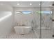 This elegant bathroom features a modern tub and a spacious glass-enclosed shower at 9820 N 87Th Pl, Scottsdale, AZ 85258