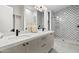 Elegant bathroom with marble countertops, dual sinks, and a stylish tiled walk-in shower at 9820 N 87Th Pl, Scottsdale, AZ 85258
