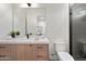 Modern bathroom with floating vanity, marble countertop, and a dark tiled shower at 9820 N 87Th Pl, Scottsdale, AZ 85258