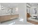 The ensuite bathroom has dual sinks, decorative lighting, and beautiful tile flooring at 9820 N 87Th Pl, Scottsdale, AZ 85258