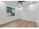 Minimalist bedroom with hardwood floors, a large window, and modern black trim at 9820 N 87Th Pl, Scottsdale, AZ 85258