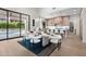 A modern dining area and kitchen with an open floor plan, a wooden dining table, and access to the outdoor patio at 9820 N 87Th Pl, Scottsdale, AZ 85258