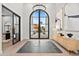 The home features a grand foyer with a large arched window, elegant light fixtures, and a modern console table at 9820 N 87Th Pl, Scottsdale, AZ 85258