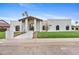 An inviting, modern, single-story home featuring a crisp white stucco exterior and an arched entryway at 9820 N 87Th Pl, Scottsdale, AZ 85258