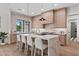 Well-lit kitchen island with bar stools, marble countertops, and pendant lighting at 9820 N 87Th Pl, Scottsdale, AZ 85258