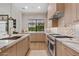 Stylish kitchen showcases stainless steel appliances, marble countertops, and modern cabinetry at 9820 N 87Th Pl, Scottsdale, AZ 85258