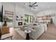 A spacious living room with a modern fireplace, large windows overlooking the yard, and a comfortable seating arrangement at 9820 N 87Th Pl, Scottsdale, AZ 85258