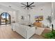 The living room features high ceilings, a modern fan, and a comfortable white sofa set at 9820 N 87Th Pl, Scottsdale, AZ 85258