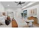 Bright main bedroom with luxurious bedding, stylish seating, and modern decor at 9820 N 87Th Pl, Scottsdale, AZ 85258