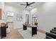 This office features a ceiling fan, black desk, and a view to the outdoors at 9820 N 87Th Pl, Scottsdale, AZ 85258