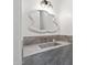 Chic powder room featuring a marble countertop vanity with designer mirror and fixtures at 9820 N 87Th Pl, Scottsdale, AZ 85258
