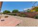 Backyard features a brick patio, rock landscaping, a brick wall and green bushes at 10236 N 105Th Dr, Sun City, AZ 85351