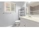 Cozy bathroom featuring a white vanity, with natural lighting through a window and tile flooring at 10236 N 105Th Dr, Sun City, AZ 85351