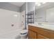 Bathroom features a shower over tub, a vanity, and three light fixture over the mirror at 10236 N 105Th Dr, Sun City, AZ 85351