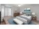 Comfortable bedroom with a tufted headboard, light hardwood floors, and a ceiling fan at 10236 N 105Th Dr, Sun City, AZ 85351