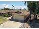 Inviting single-story home with a two-car garage and a well-maintained lawn at 10236 N 105Th Dr, Sun City, AZ 85351