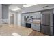 Modern kitchen featuring stainless steel appliances and sleek granite countertops at 10236 N 105Th Dr, Sun City, AZ 85351