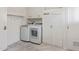 Laundry room with washer and dryer, storage shelf, coat hooks and tile floor at 10236 N 105Th Dr, Sun City, AZ 85351