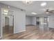 Open-concept living room with wood-look floors, ceiling fan and access to the patio at 10236 N 105Th Dr, Sun City, AZ 85351