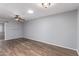 Bright room with wood-look floors, ceiling fan and a neutral color scheme at 10236 N 105Th Dr, Sun City, AZ 85351