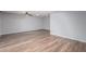 Spacious room with wood floors, ceiling fan, and neutral color scheme at 10236 N 105Th Dr, Sun City, AZ 85351