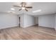 Bright living room with ceiling fan, wood-look floors and ample natural light at 10236 N 105Th Dr, Sun City, AZ 85351