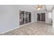 Bright sunroom with tile floor, ceiling fan, and sliding glass doors looking into another room at 10236 N 105Th Dr, Sun City, AZ 85351