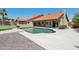 Exterior view of a house featuring a pool, outdoor living space, and a well-maintained yard at 10450 E Terra Dr, Scottsdale, AZ 85258