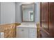 Charming bathroom with decorative tile, marble countertop, and dark wood door at 10450 E Terra Dr, Scottsdale, AZ 85258