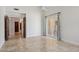 Open bedroom with tile flooring, ceiling fan, access to the patio, and connected to a hallway at 10450 E Terra Dr, Scottsdale, AZ 85258