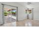 Spacious bedroom with sliding glass doors leading to the patio and pool, and large windows at 10450 E Terra Dr, Scottsdale, AZ 85258