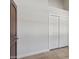 Bedroom with travertine tile and a brown door, and a mirrored sliding door closet at 10450 E Terra Dr, Scottsdale, AZ 85258