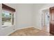 Bright bedroom with tile flooring, door to the bathroom, a window, and custom blinds at 10450 E Terra Dr, Scottsdale, AZ 85258