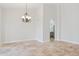 Spacious dining room featuring travertine floors, a decorative light fixture, and archway to the kitchen at 10450 E Terra Dr, Scottsdale, AZ 85258