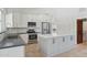 This open kitchen boasts modern appliances, generous cabinet space, a central island, and tile flooring at 10450 E Terra Dr, Scottsdale, AZ 85258