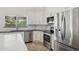 This spacious kitchen boasts stainless steel appliances, stone countertops, and bright white cabinets at 10450 E Terra Dr, Scottsdale, AZ 85258