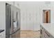 Bright kitchen features stainless steel refrigerator and ample storage with white cabinets on the adjacent wall at 10450 E Terra Dr, Scottsdale, AZ 85258