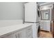 Efficient laundry area with stacked washer and dryer, counter space, and stylish bathroom in view at 10450 E Terra Dr, Scottsdale, AZ 85258