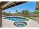 Stunning backyard featuring a pool, hot tub, putting green, and ample patio space at 10450 E Terra Dr, Scottsdale, AZ 85258