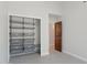 Walk-in closet featuring built-in wire shelving, carpet, and an open doorway to the Primary bathroom at 10450 E Terra Dr, Scottsdale, AZ 85258