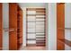 Spacious walk in closet with custom shelving and hanging bars providing lots of storage at 10450 E Terra Dr, Scottsdale, AZ 85258